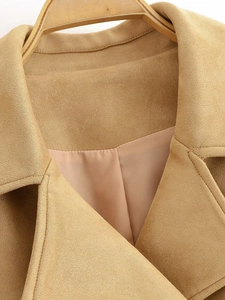 Detailed view of khaki suede coat featuring classic wide lapels and smooth satin lining