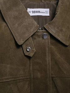 Detailed view of dark olive green faux suede collar with metal snap and size label