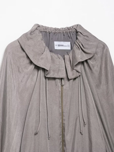Detail of dark grey pilot jacket collar with ruffle trim and metal zipper closure
