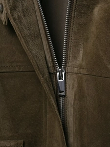 Detailed close-up of high-quality suede jacket texture and durable silver metal zipper