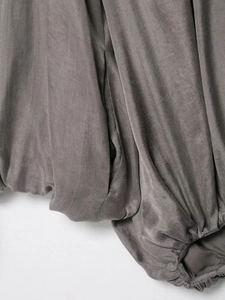 Detail of dark grey bomber jacket elastic hem with seamless stitching and side pocket
