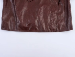 Detail of high-quality dark brown faux leather hem with precise double stitching
