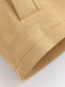 Detail of camel suede jacket cuff featuring high-quality double stitching and texture