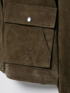 Detail of olive green suede jacket with large flap pocket and silver snap button