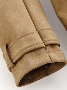 Close-up of sleeve cuffs with adjustable straps on a camel double-breasted trench coat
