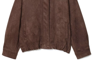 Detail of faux suede jacket with elastic hem and side pockets in brown color