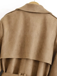 Detail view of khaki faux suede trench coat back with storm flap and fabric texture