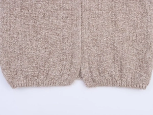 Close-up of ribbed hem details on oatmeal oversized wool knit cardigan sweater