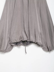 Detailed view of grey bomber jacket with drawstring hem and metallic zipper finish