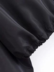Nahaufnahme der elastischen Rippbündchen an einer schwarzen winddichten Jacke mit feiner Naht