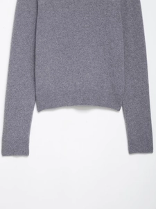 Close-up of ribbed cuffs and hem on a premium grey knit sweater for women