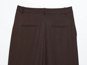 Detailed back view of dark brown trousers showing waist loops and welt pockets