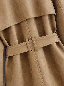 Detail of camel suede trench coat featuring back storm flap and belted waist design