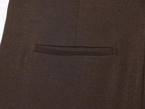 Macro view of a well-crafted brown welt pocket on a twill fabric women's vest jacket