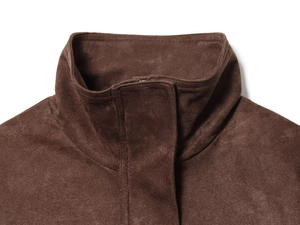 Detail shot of a dark brown suede jacket with a high collar and hidden placket design