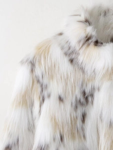 Detailed view of luxury faux fur texture with ivory and brown leopard spots pattern