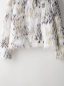 Detailed close-up showing the dense snow leopard print faux fur texture and sleeve cuff