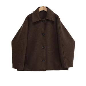Detailed view of dark brown wool coat with classic lapels and round black buttons