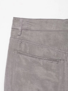 Macro detail of grey pilot trousers showing high-quality twill fabric and back pocket stitching