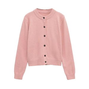 Detail of pink crewneck cardigan showing ribbed cuffs and black buttons on knit fabric