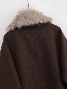 Detail of dark brown wool coat with detachable light grey faux fur collar and back stitching