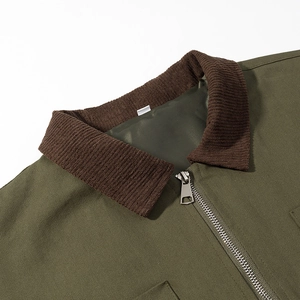 Detail of army green jacket collar with brown corduroy and silver metal zipper