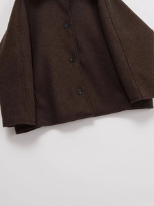 Close-up of brown wool blend jacket with high-quality fabric texture and black buttons