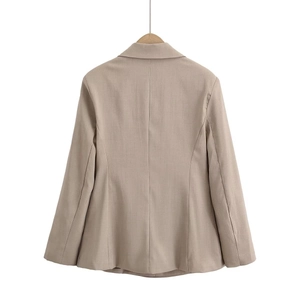 Back view of beige blazer featuring sharp tailoring and premium textured fabric