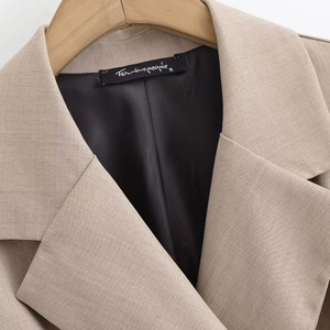 Detail shot of khaki blazer lapel with high-quality twill fabric and sleek black lining