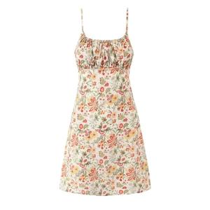 Detailed close-up of floral summer mini dress with thin straps and ruched bust design