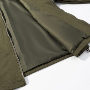 Detail of olive green jacket featuring smooth satin lining and silver metal zipper