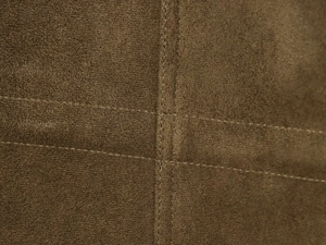 Detailed close-up of stitching on dark brown suede fabric for women's hooded jacket