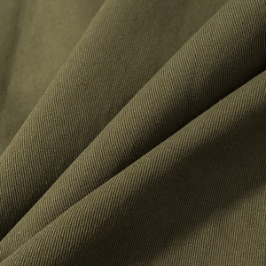 Detailed macro view of olive green twill fabric texture on a casual zip jacket