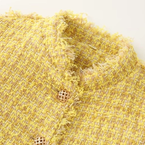 Classic yellow tweed jacket with fringe trim and golden woven buttons for women