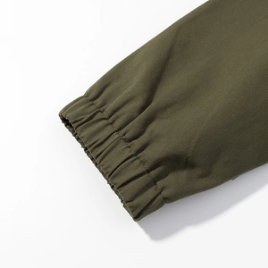Detail of olive green twill jacket sleeve showing ribbed elastic cuffs and stitching