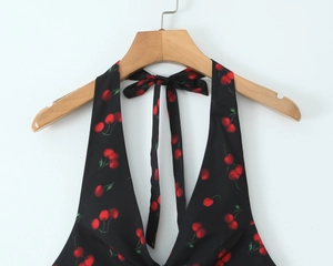 Detail of black cherry print halter neck tie knot on the back of a slim mini dress
