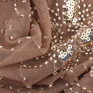 Sequin halter crop top featuring silver beads on beige mesh fabric for a sexy street look