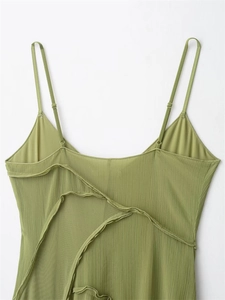 Detail of green dress featuring adjustable spaghetti straps and layered ruffled back