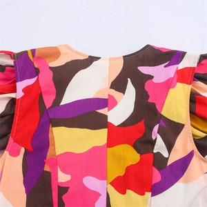 Detailed close-up of crew neckline and colorful abstract geometric print on sleeveless dress