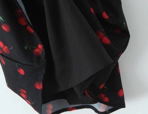 Detail of black cherry print dress showing the inner lining and high-quality hem stitching