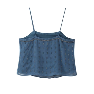 Detail of blue backless camisole top with vertical beadwork and wavy beaded trim