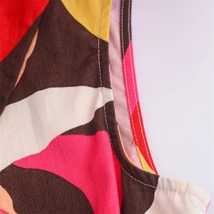 Detail of high-quality double-needle stitching on abstract geometric printed fabric