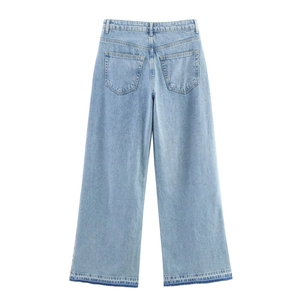 Detail view of high waist wide leg jeans with distressed hem and back pocket design