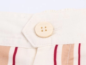 Detailed close-up of vertical striped fabric texture and resin button on trousers