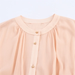 Elegant pink pleated chiffon blouse featuring gold ball buttons and a round neckline