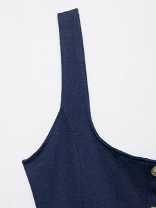 Detailed macro view of navy blue textured fabric with a premium embossed gold button