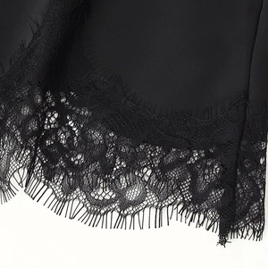Elegant black satin top with delicate eyelash lace hem and intricate floral details