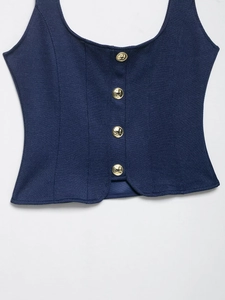 Close-up of navy twill vest top featuring four decorative gold metal buttons and structured cut