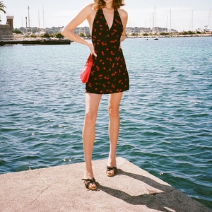 Sweet black halter neck mini dress with cherry print and open back for summer vacation