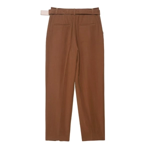 Detail view of brown straight trousers with matching belt and rear welt pockets